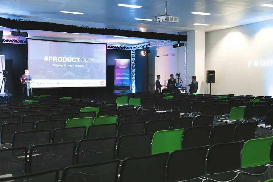 Conference hall with large screens and stage lighting