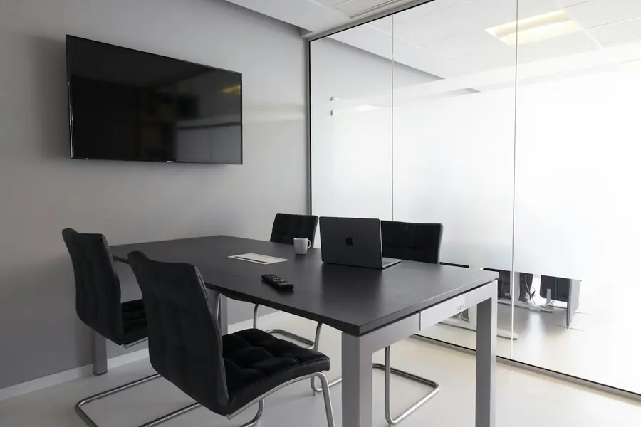 Meeting room with a wall-mounted display for video conferencing